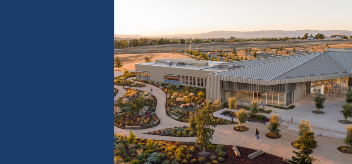 aerial photo of the Gavilan College Hollister campus building with two people walking on the path