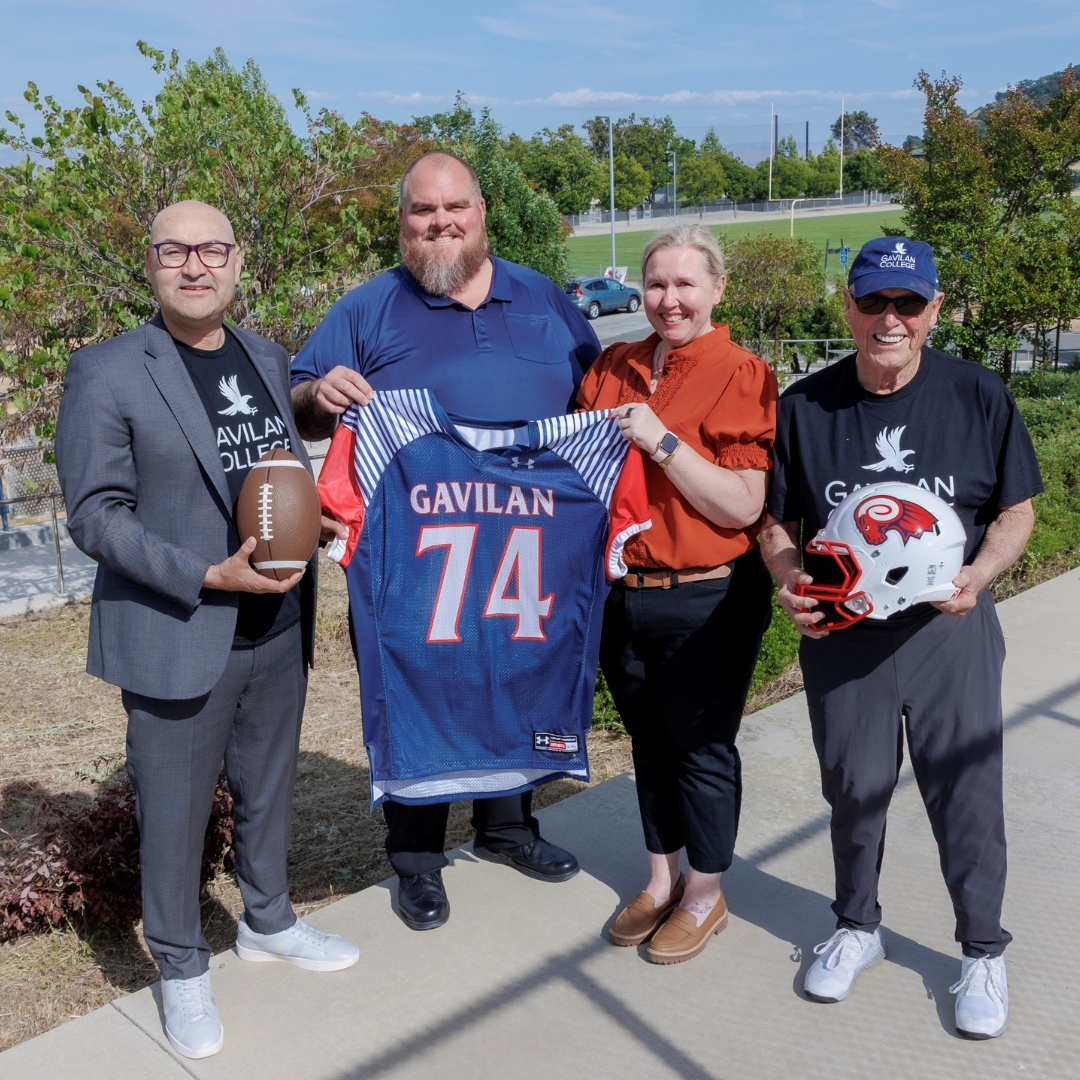 Image of Dr. Pedro Avila, Joffre Longoria, Jamie Adams, and Bob Garcia standing in front of a football field.